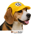 Dog wearing a yellow cap with a soccer ball design, featuring the BeagleBuddy brand.